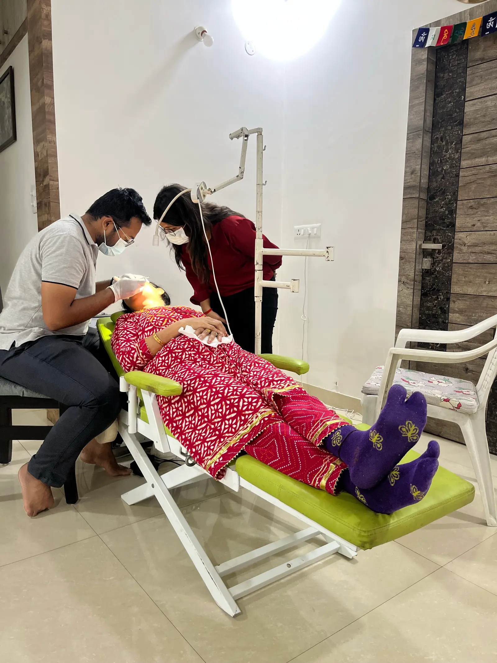 Two Prudentoe dentists performing dental treatment at a patient's home in Hyderabad